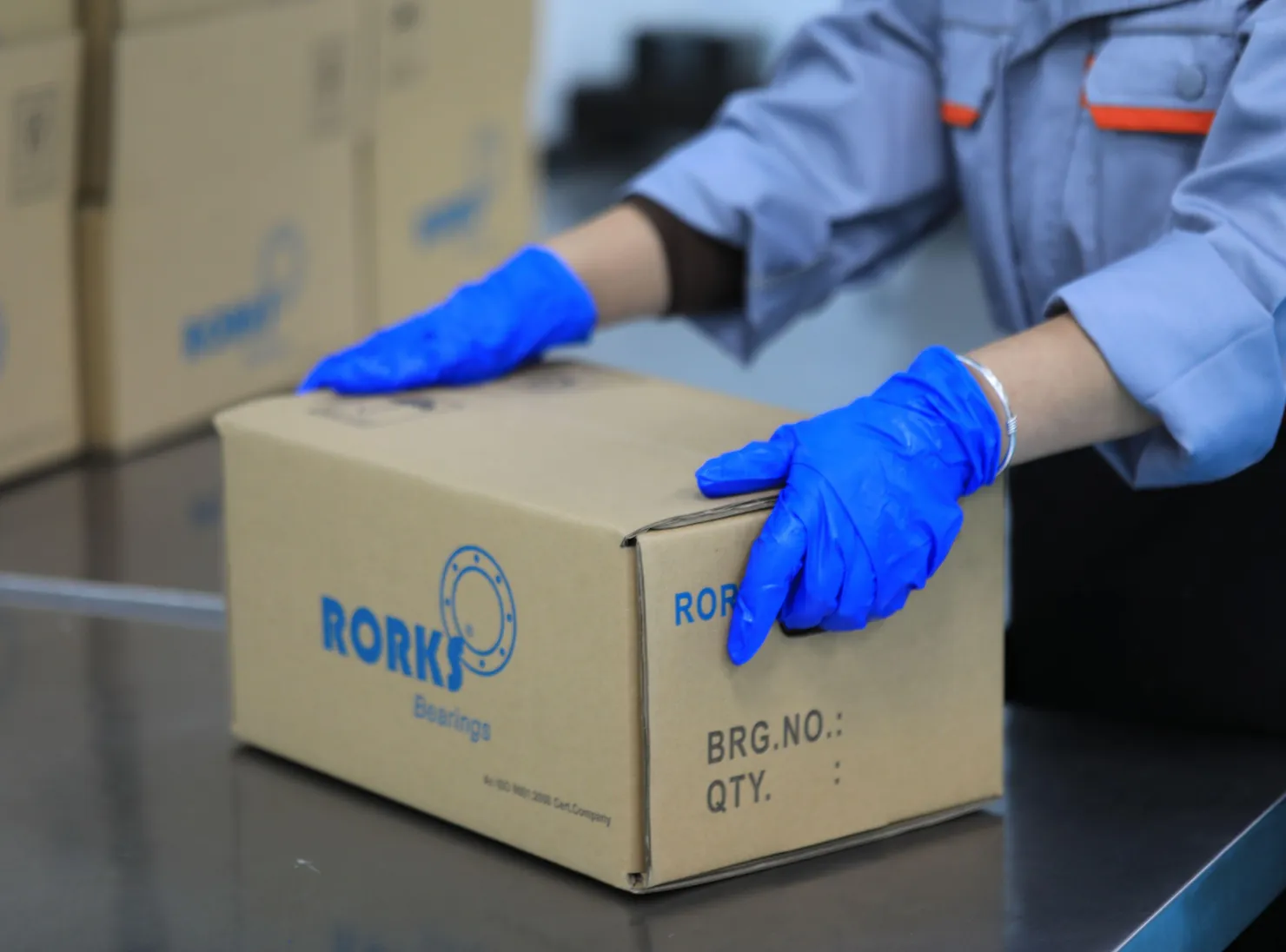 Person handling THB bearing packaging with Rorks branding